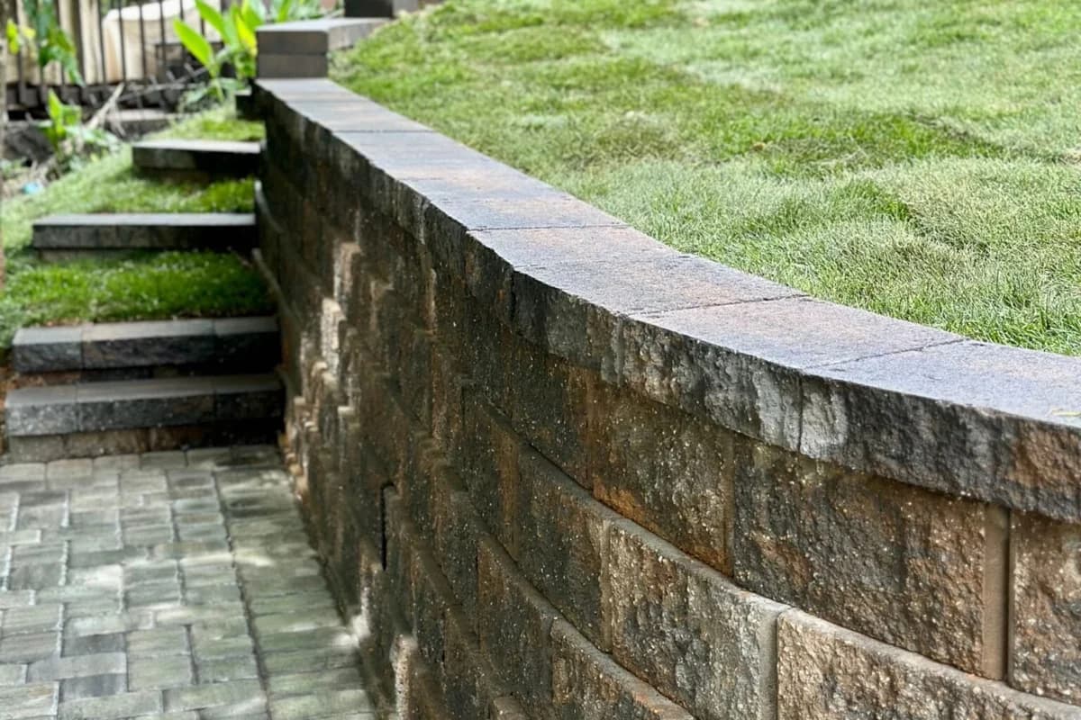 Paver patio, curved block wall and steps built by Urban