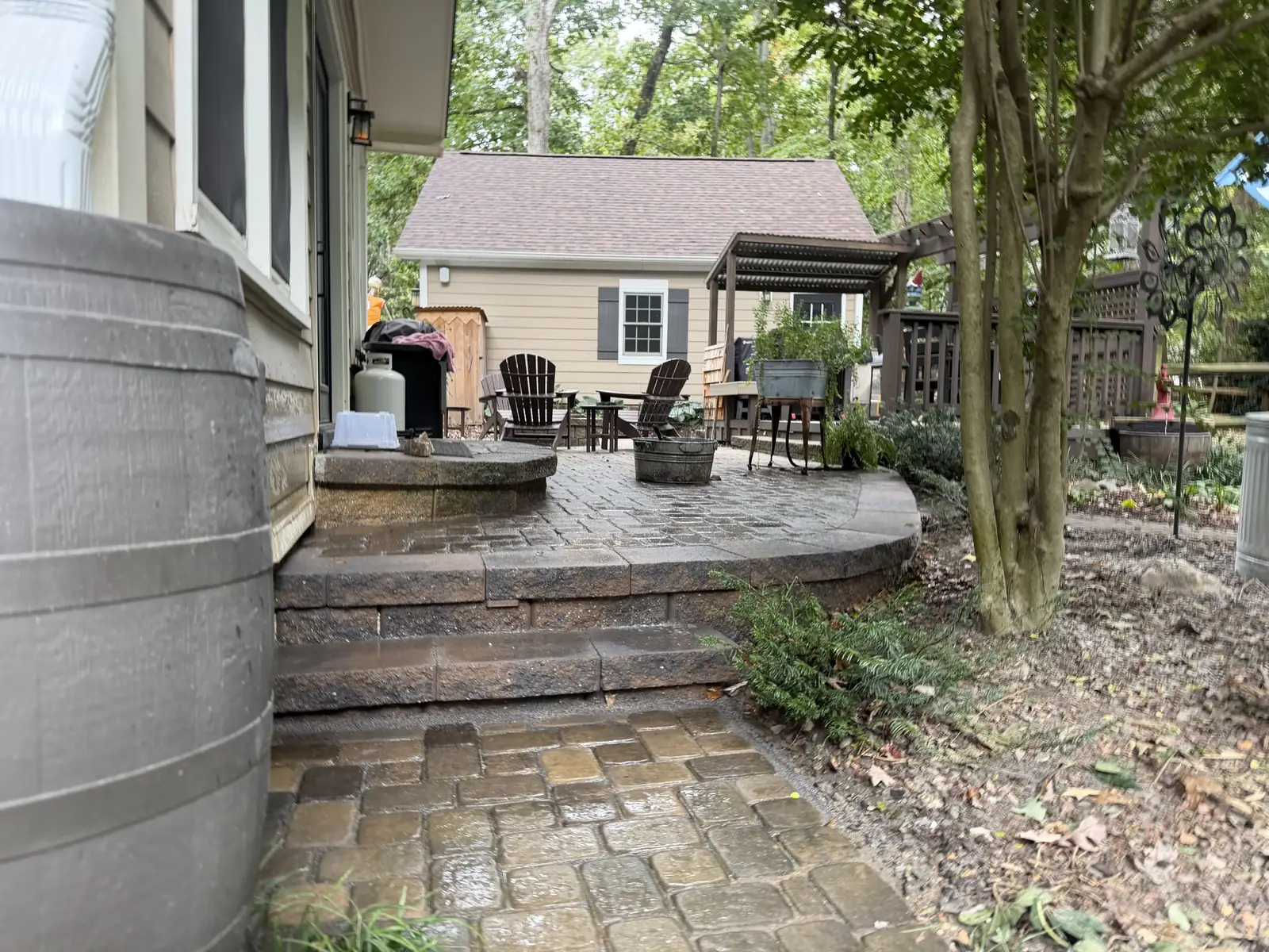 Paver walkway meeting the steps of an existing raised patio