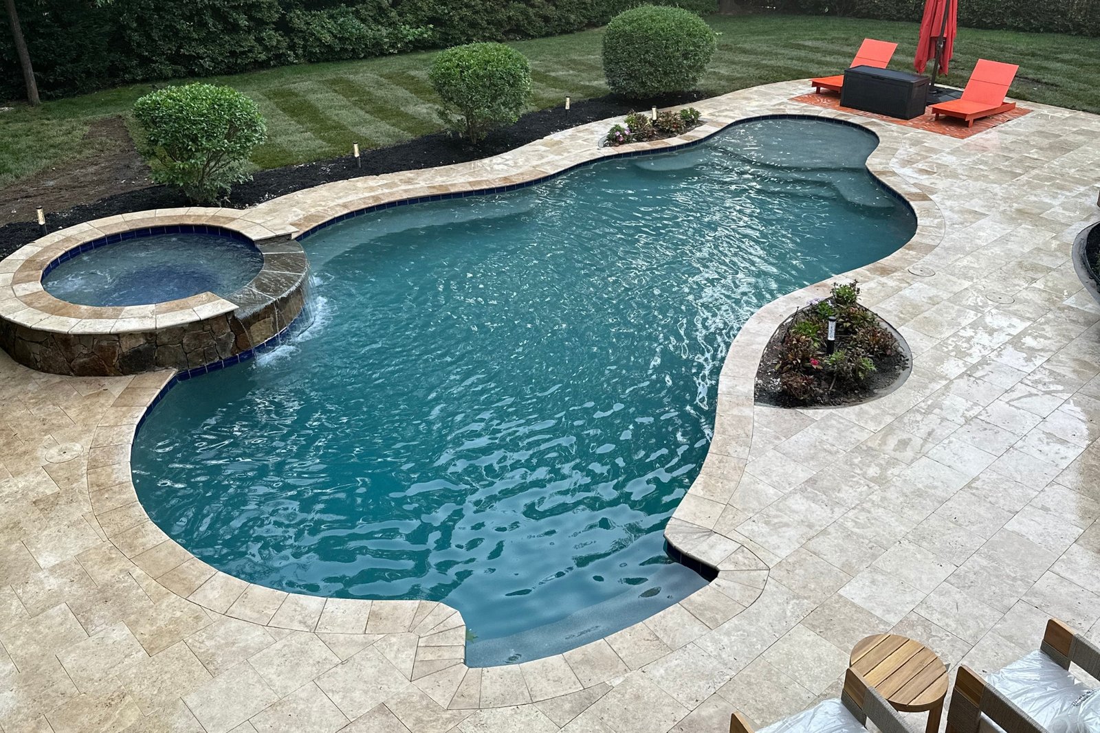 Completed travertine pool deck at the Lakefront Luxury Retreat project