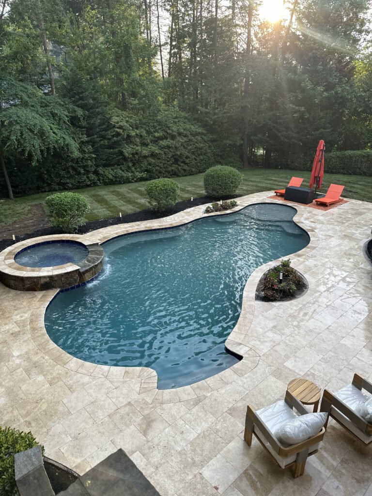 Overhead view of the travertine deck surrounding the pool and hot tub
