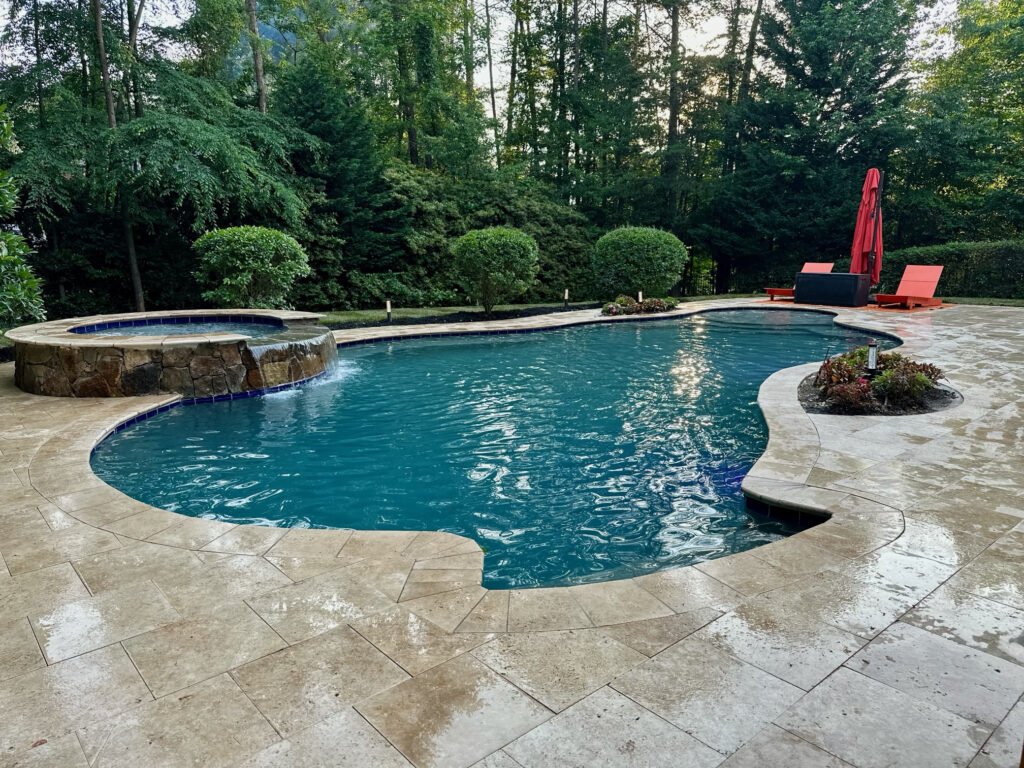 Wide view of the completed travertine pool deck and hot tub
