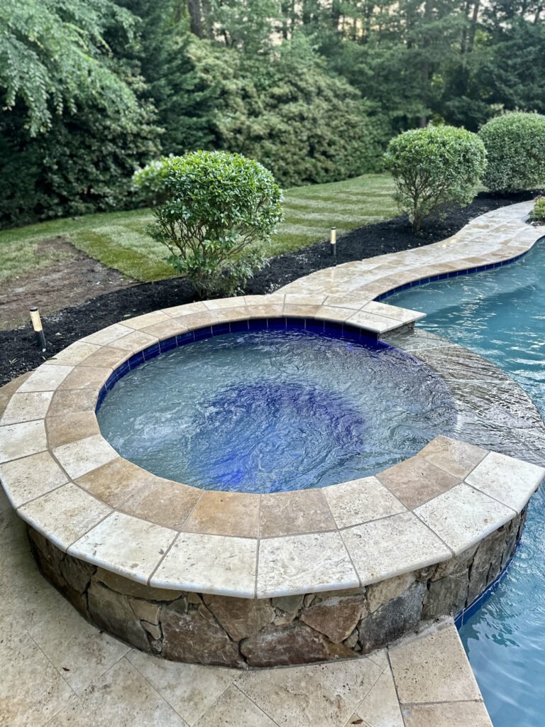 Finished coping around the raised hot tub beside the pool