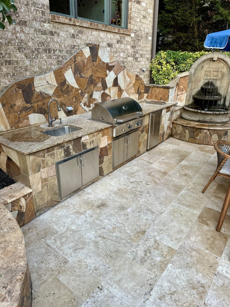 Travertine patio meeting the existing outdoor kitchen