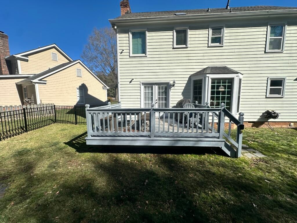 Closer original view of the raised deck, stairs, and back entrance