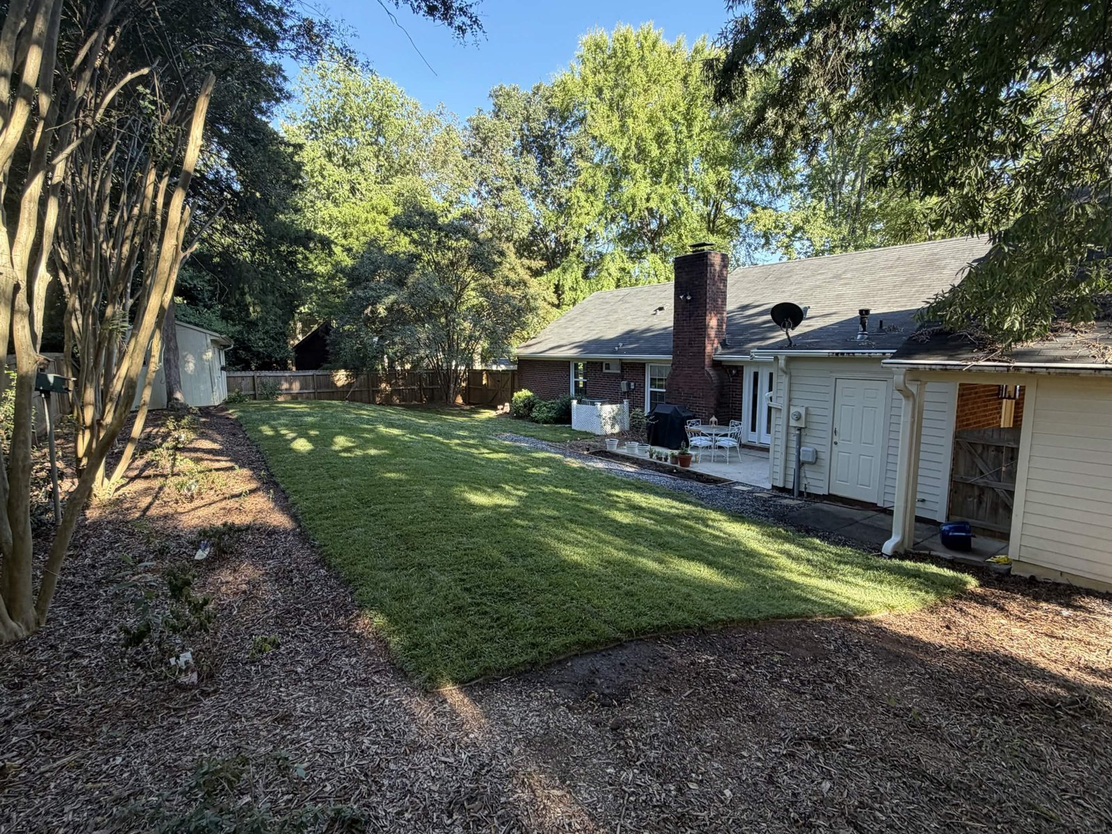 Fresh sod throughout a renovated backyard