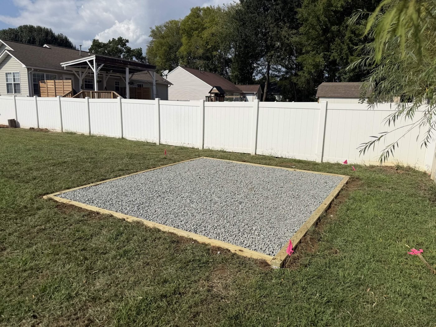 Backyard Gravel Pad 2 Finished backyard gravel pad with a timber border beside the white fence
