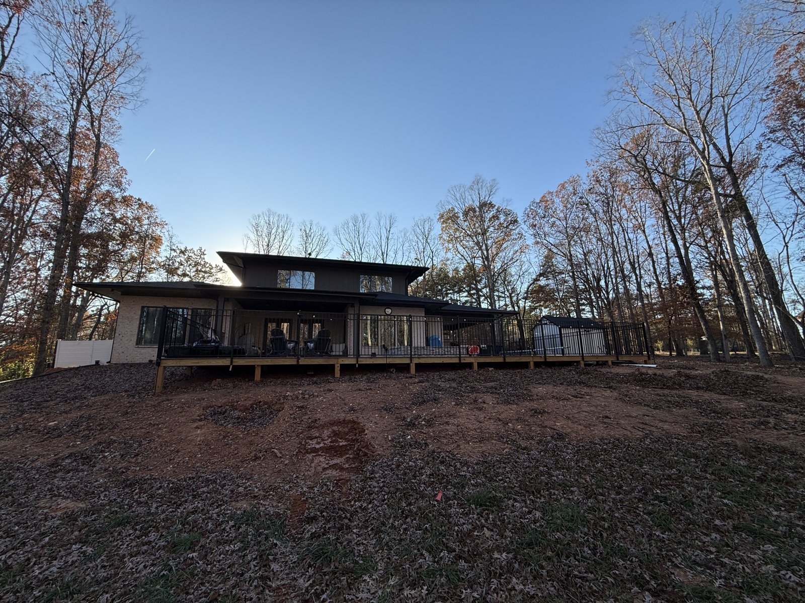 Wide view of the backyard and existing deck before the retaining wall project