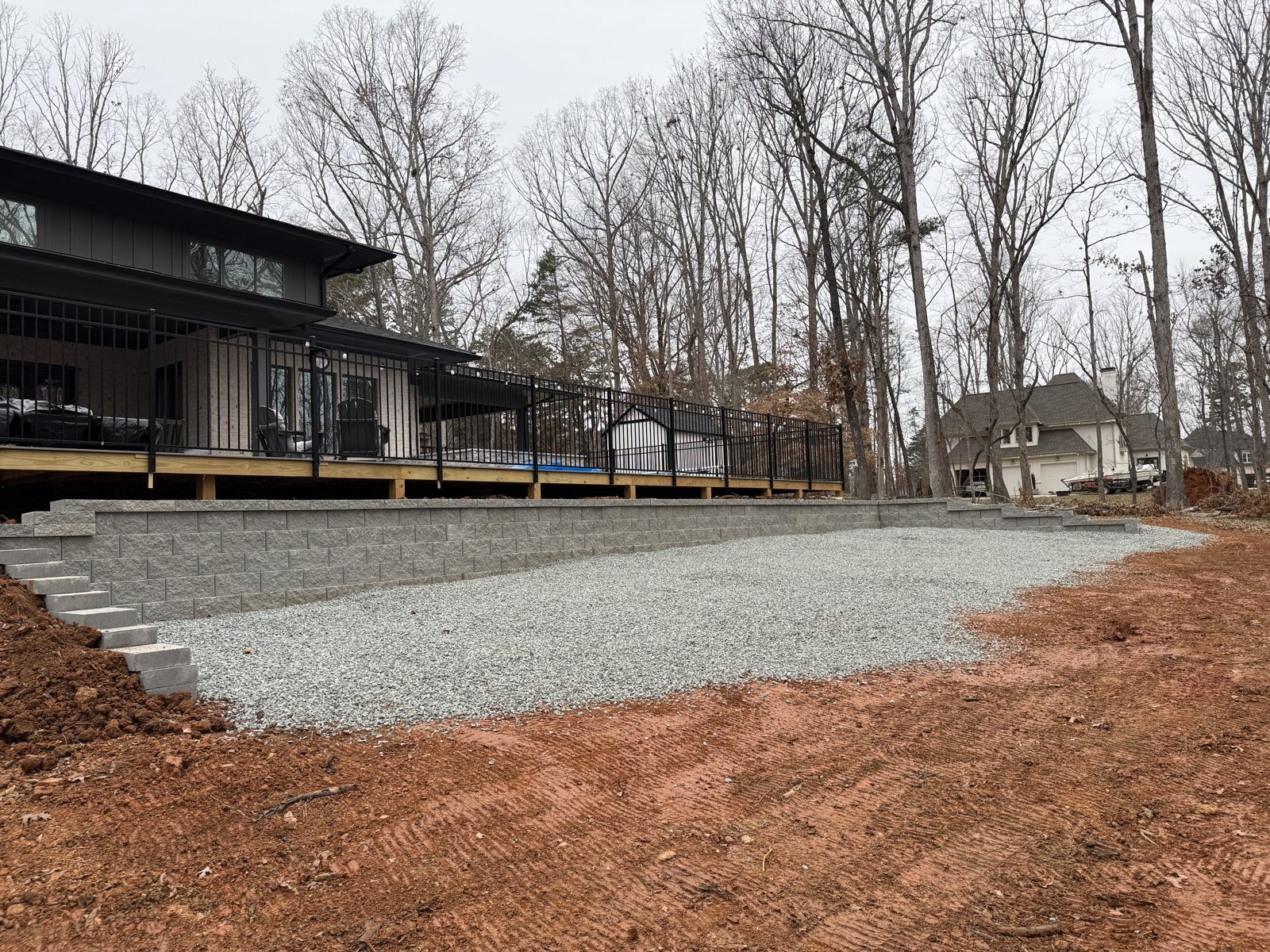 Completed retaining wall below a deck with a gravel area in Mint Hill