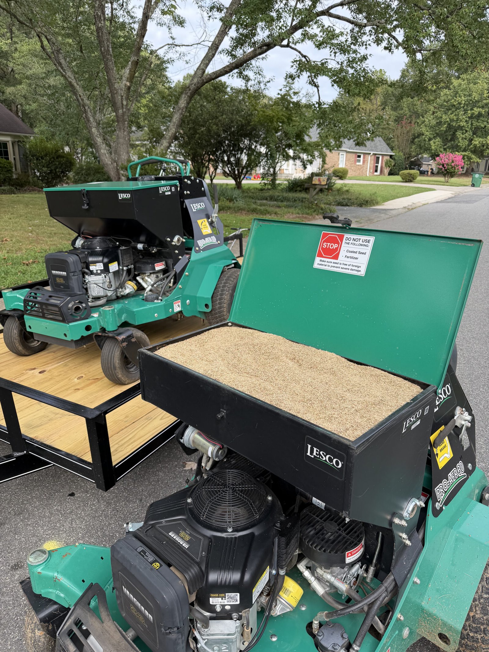 Urban aeration machine with seed visible in its open hopper